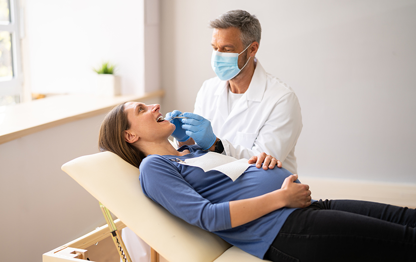 pregnant woman receiving dental treatment