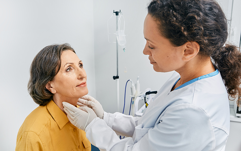 Doctor touching patient's neck 