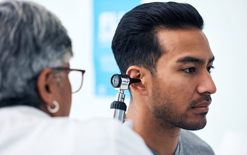 Man having ears examined