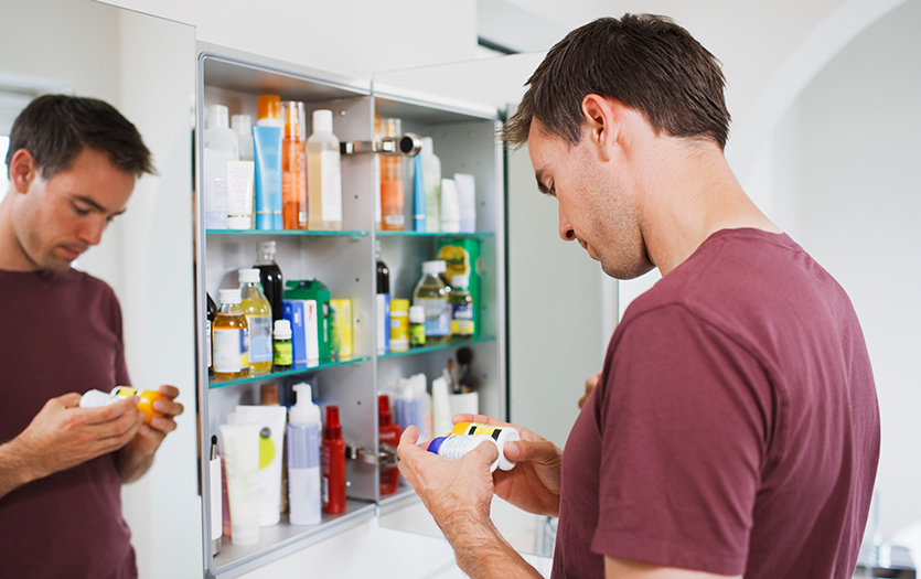 Man looking in medicine cabinet